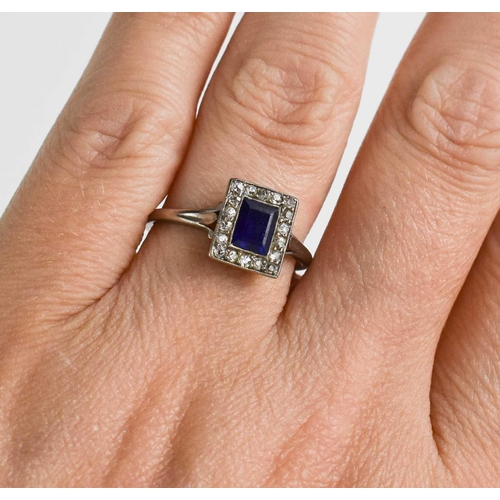 51 - A white metal, diamond and sapphire ring, the rectangular cut sapphire bordered by chip diamonds, si... 