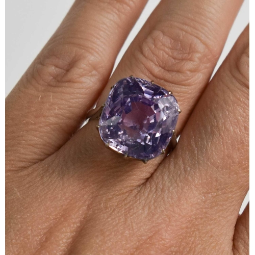 52 - A white metal (likely platinum) and pale lilac sapphire ring, the cushion cut lilac coloured sapphir... 