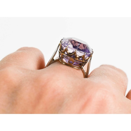 52 - A white metal (likely platinum) and pale lilac sapphire ring, the cushion cut lilac coloured sapphir... 