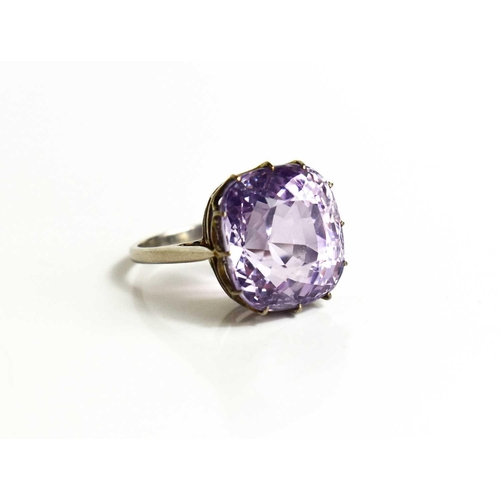 52 - A white metal (likely platinum) and pale lilac sapphire ring, the cushion cut lilac coloured sapphir... 