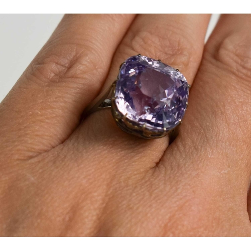 52 - A white metal (likely platinum) and pale lilac sapphire ring, the cushion cut lilac coloured sapphir... 