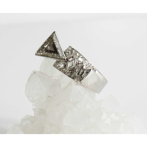 64 - A contemporary 18ct white gold and diamond ring, bespoke commission, size T, the primary trilliant c... 