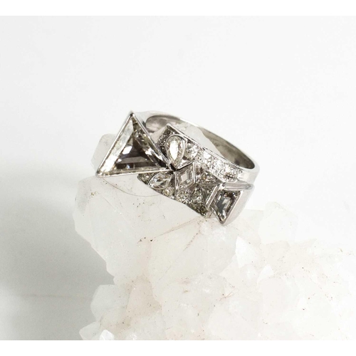 64 - A contemporary 18ct white gold and diamond ring, bespoke commission, size T, the primary trilliant c... 