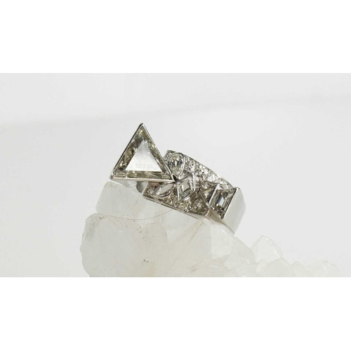 64 - A contemporary 18ct white gold and diamond ring, bespoke commission, size T, the primary trilliant c... 