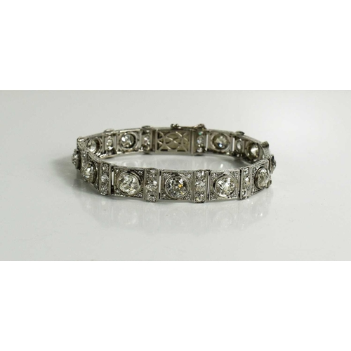 65 - An exceptional Art Deco period platinum and diamond bracelet, each of the eleven primary links set w... 