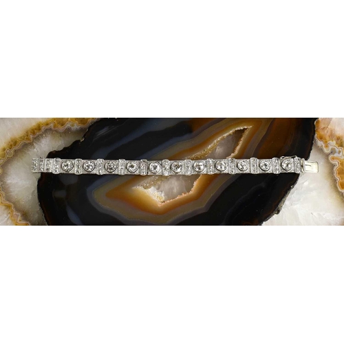 65 - An exceptional Art Deco period platinum and diamond bracelet, each of the eleven primary links set w... 