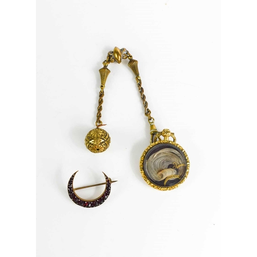 76 - A Victorian gilt metal mourning locket and chain with ball pendant and locks of hair, and a yellow m... 