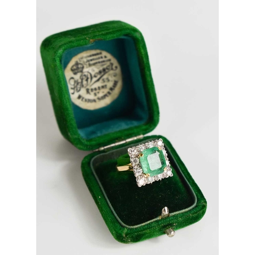 8 - An 18ct yellow gold, emerald and diamond ring, the cushion cut emerald bordered by twelve brilliant ... 