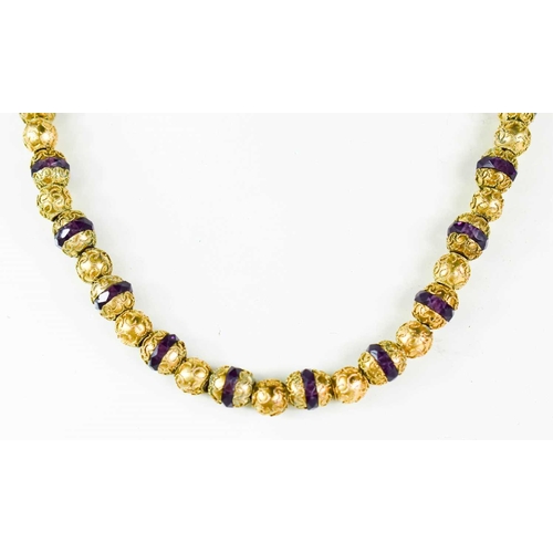 80 - A mid-19th century amethyst and gilt metal beaded necklace, with barrel clasp.