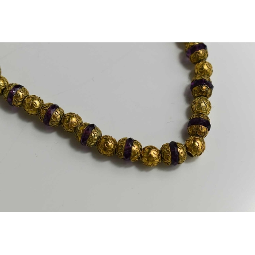 80 - A mid-19th century amethyst and gilt metal beaded necklace, with barrel clasp.