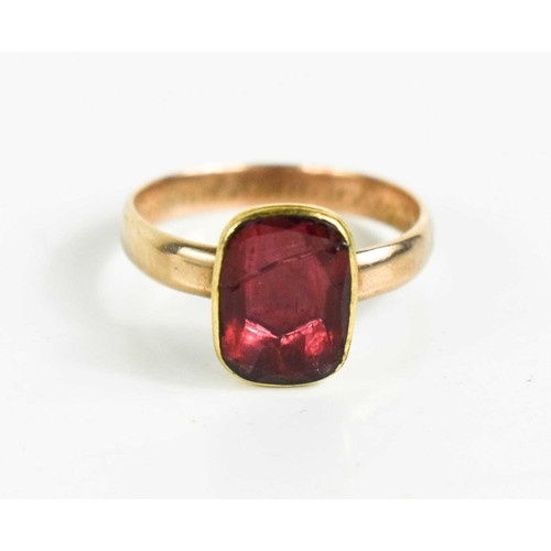 9 - A Georgian gold [tested as] and foil backed pink paste ring, inscribed John Mcdonald Kinnier Esq of ... 