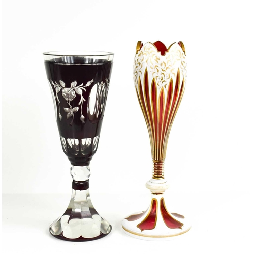 133 - A cranberry glass goblet, likely Austrian, with cameo decoration, the red glass cut back to clear pa... 