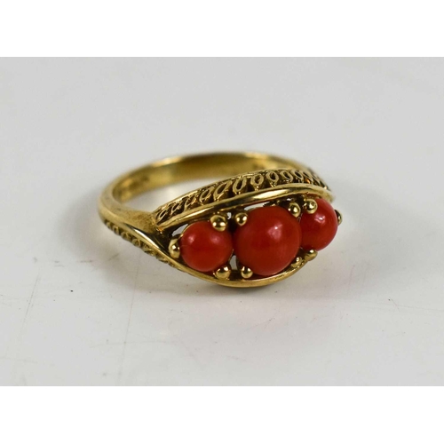 10 - A 9ct gold and coral three stone ring.