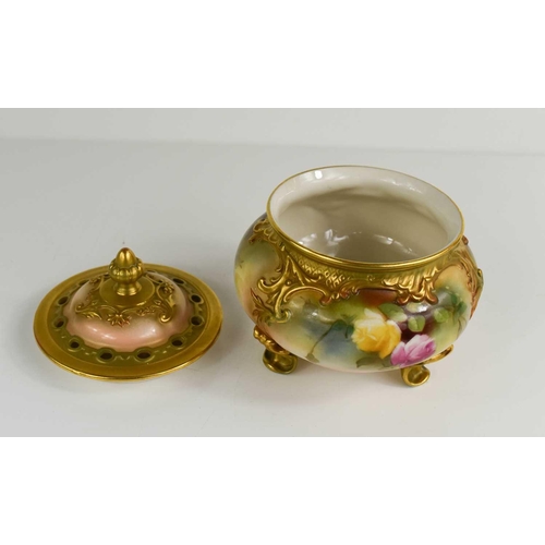 100 - A Royal Worcester pot pourri vase and cover, painted with roses, raised on three feet, 13cm high.The... 