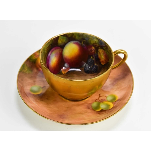 106 - A Royal Worcester cup and saucer, the cup painted with fruit to the interior with peaches and blackb... 