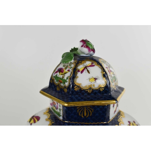 111 - A pair of 19th century hexagonal vases and covers, decorated with birds and insects on a cobalt blue... 