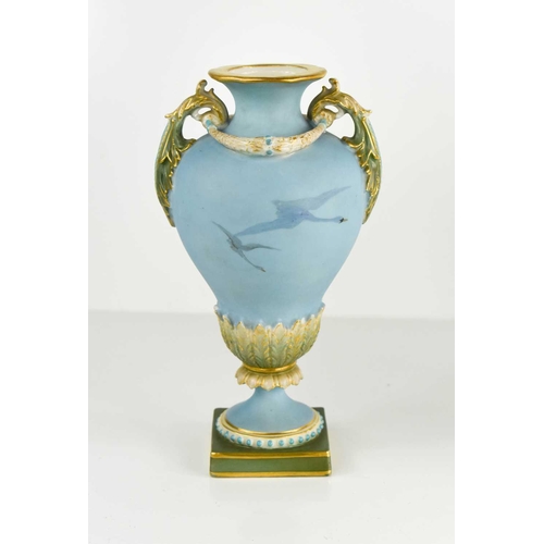 124 - A Royal Worcester Charles Baldwin twin handled pedestal vase, circa 1920, painted to a blue backgrou... 