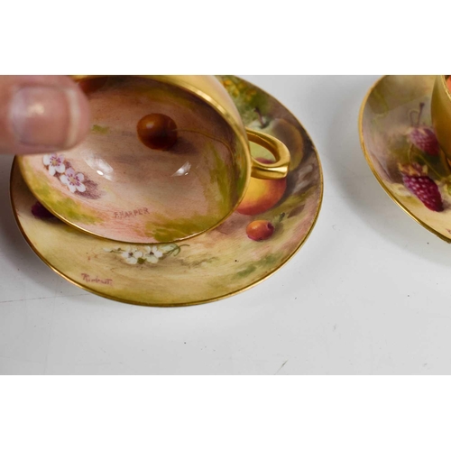 131 - A pair of Royal Worcester miniature cups and saucers, painted with fruits to mossy ground, puce mark... 