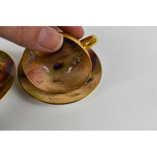 132 - A pair of Royal Worcester miniature cups and saucers, painted with fruits to mossy ground, puce mark... 