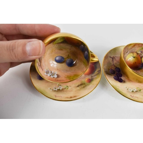 132 - A pair of Royal Worcester miniature cups and saucers, painted with fruits to mossy ground, puce mark... 