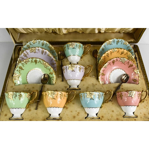 143 - A cased set of Royal Crown Derby tea cups and saucers, in a variety of colours, shaped with vine pat... 