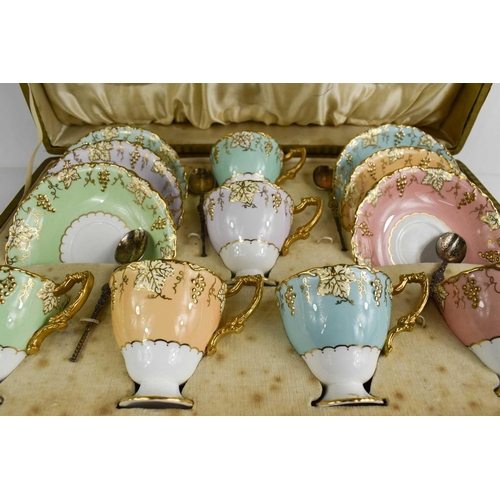 143 - A cased set of Royal Crown Derby tea cups and saucers, in a variety of colours, shaped with vine pat... 