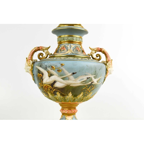 158 - A fine Royal Worcester pedestal vase and cover, painted with swans in flight, by Baldwyn, to a powde... 