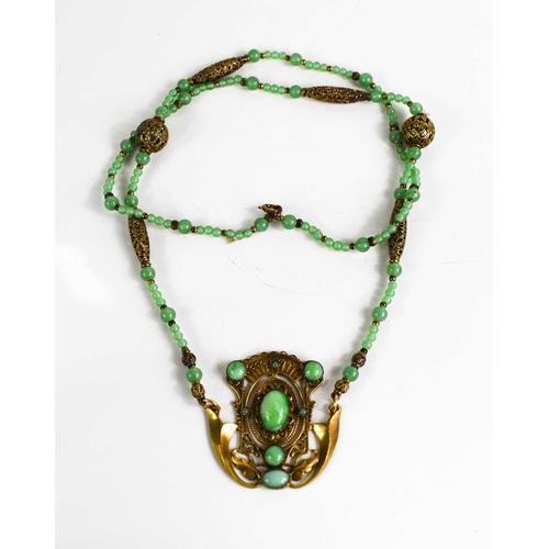 18 - An Art Noveau style jade and gold coloured metal pendant necklace.