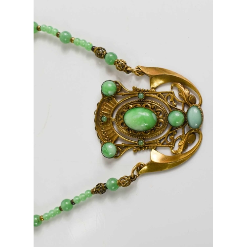 18 - An Art Noveau style jade and gold coloured metal pendant necklace.