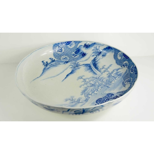 229 - A large Japanese blue and white charger, depicting a landscape scene, 46cm diameter.