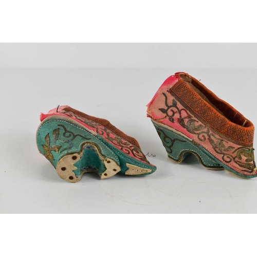 233 - A pair of 19th century Chinese lotus shoes in silk, decorated with gold/silver coloured embroidery, ... 