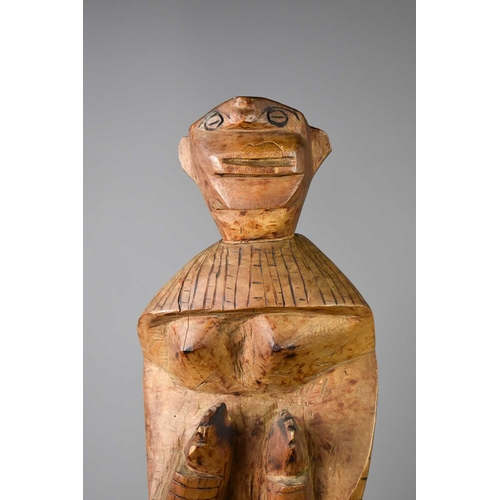 240 - A large carved African figure of a woman, possibly Tswana, with hands raised, with carved decoration... 