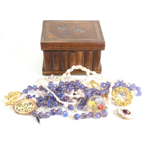 25 - A vintage wooden jewellery box with secret compartment together with a small group of costume jewell... 