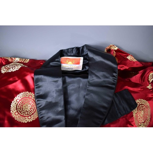 274 - A gentleman's Chinese silk jacket in red and black, with tie, in original box.