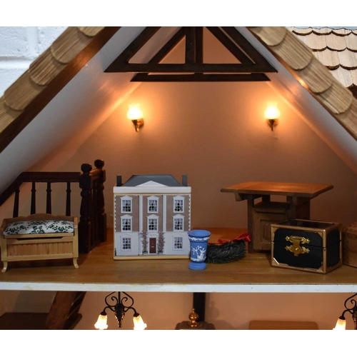 324 - A Swiss cottage or chalet doll's house, complete with electrics and dolls, furniture and accessories... 