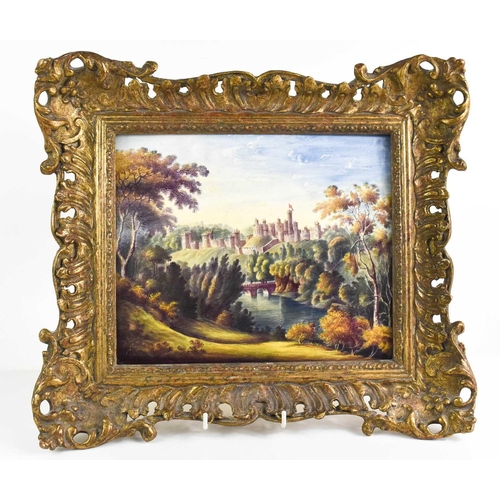 449 - A 19th century oil on porcelain plaque, depicting a castle in the distance, with figures on a bridge... 