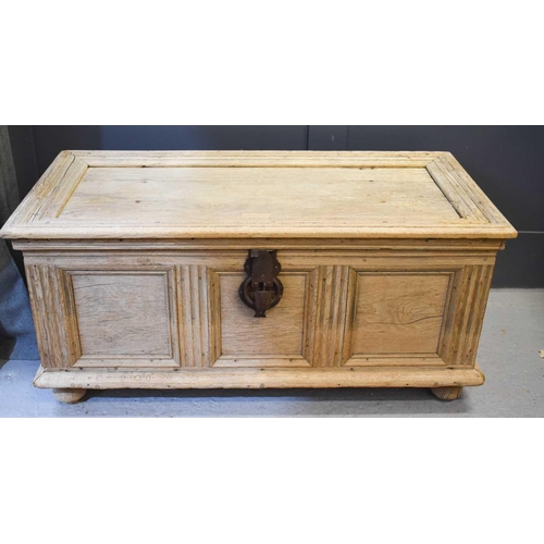 532 - A 19th century Continental oak chest with iron handles and raised on bun feet, 56cm high by 122cm wi... 