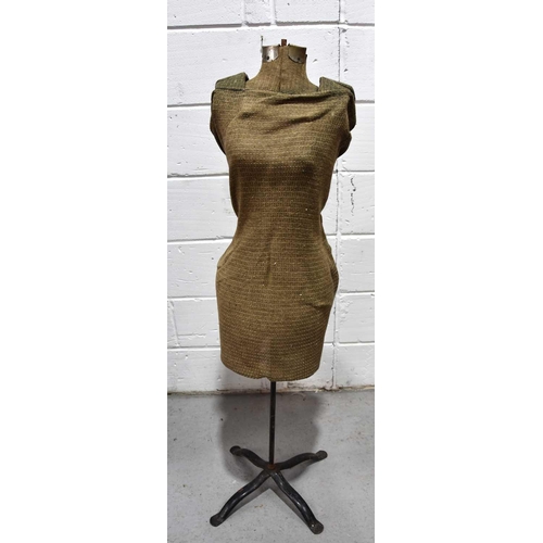 541 - A vintage dress makers mannequin raised on steel tripod base.