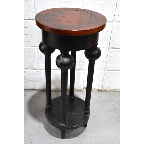 542 - A modern ebonised occasional table with boldly turned legs and lower platform, 87cm high together wi... 