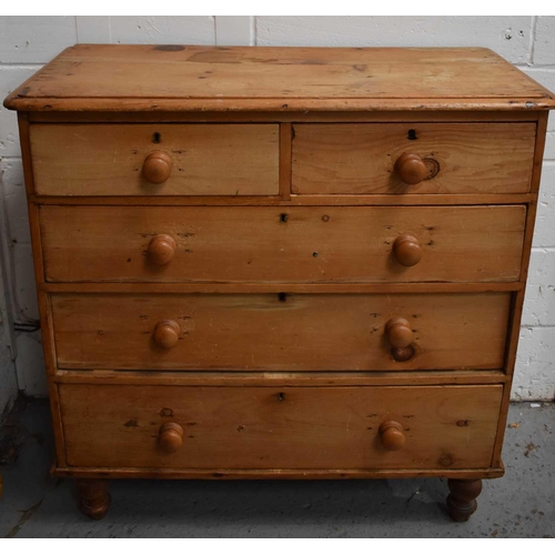 550 - An antique pine chest of drawers, with two short over three long drawers, raised on turned knop feet... 