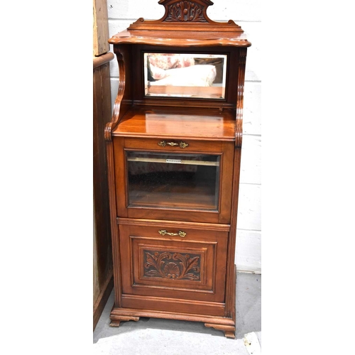 552 - A 19th century mahogany music cabinet with mirrored back, rasied on ogee bracket feet.