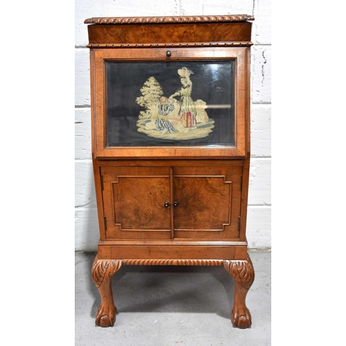 553 - A Victorian oak cabinet, possibly previously a music cabinet, the full front displaying a needlework... 