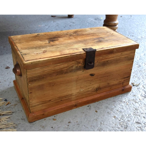 556 - A small pine chest with cup handles to the sides and drop in trays, 26cm high by 50cm by 27cm.