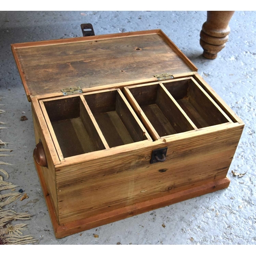 556 - A small pine chest with cup handles to the sides and drop in trays, 26cm high by 50cm by 27cm.