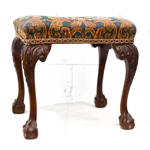 557 - A late 19th century mahogany stool in the George III style, raised on cabriole legs carved with acan... 