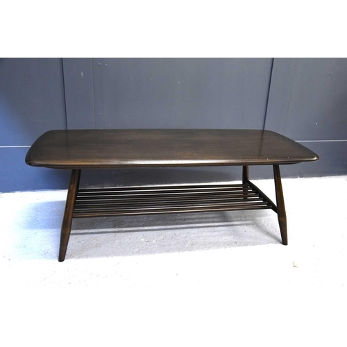 563 - An Ercol dark elm coffee table with magazine rack, 105cm wide