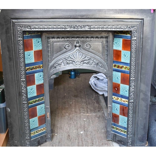 566 - A cast iron fireplace with tile inset, circa 1912.