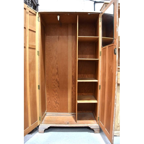 569 - A vintage 1950s wardrobe with part shelved interior, lime washed finish and two panel doors, raised ... 