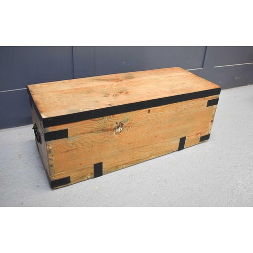 571 - An antique pine and iron clad blanket chest.