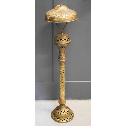 573 - A 19th century brass Indonesian lamp, possibly converted from a lantern, embossed with decoration,11... 